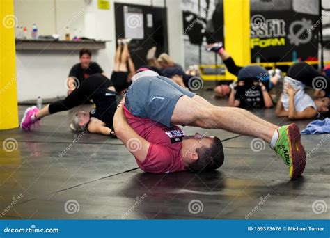 Personal Trainer Giving Fitness Instruction At A Crossfit Group Class