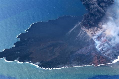 Island definition, a tract of land completely surrounded by water, and not large enough to be called a continent. Volcanic Island in Pacific Ocean Having 'Vigorous Growth ...