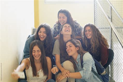 Group Of Teenagers Sitting On Stairs And Laughing By Miquel Llonch