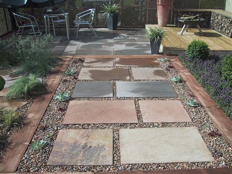 Stepping Stones In Gravel Patio Area And Raised Deck With Gabion Cage Seating Fire Pit Area