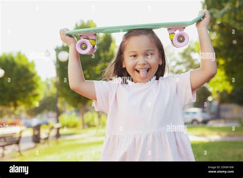Cute Happy Little Asian Girl Having Fun In The Park Posing With Her