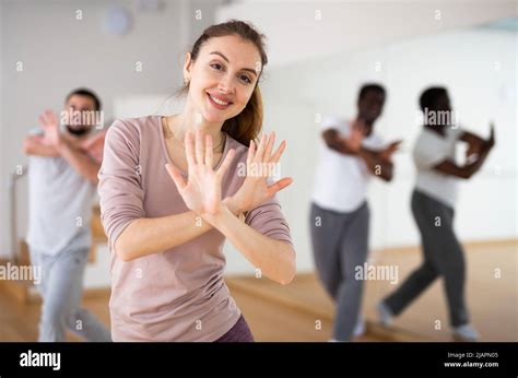 Cheerful Woman Dancing Aerobic Dance During Group Training Stock Photo