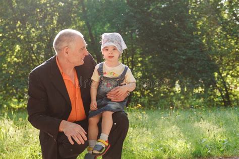 Grandfather And Granddaughter Outdoors Smiling Stock Image Image Of