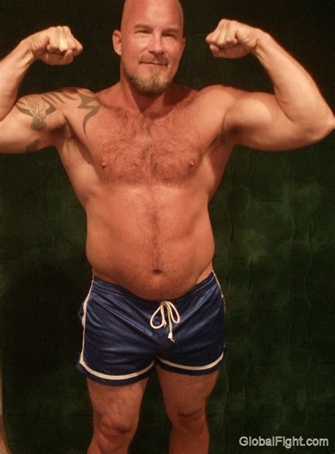 Big Burly Bald Musclebear Daddie Flexing Photo