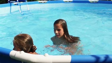 Two Cute Young Girls Swimming In A Pool Stock Video Footage Dissolve