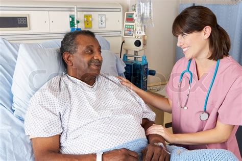 Nurse Talking To Senior Male Patient On Ward Stock Photo Colourbox