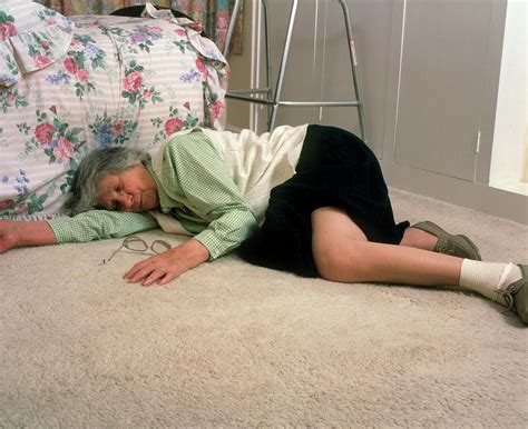 Elderly Woman Lying On Floor After A Fall Photograph By Chris Priest