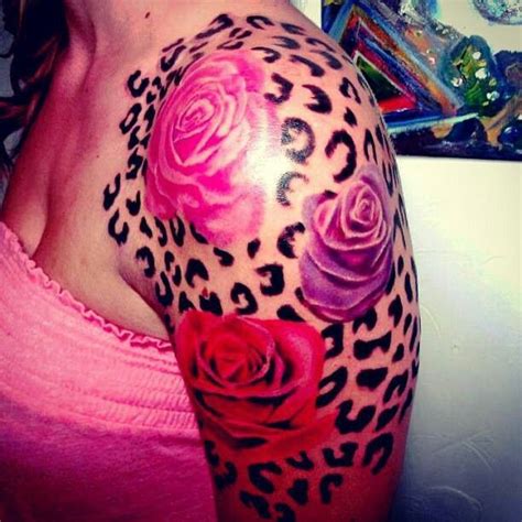 A Womans Arm With Roses And Leopard Print On It