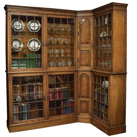 A Wooden Bookcase With Glass Doors And Shelves Filled With Books Wine