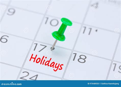 Holidays Written On A Calendar With A Green Push Pin To Remind Y Stock