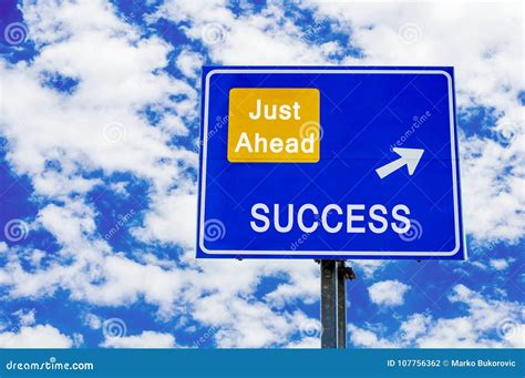 Success Just Ahead Blue Road Sign Against Blue Cloudy Sky Stock Photo