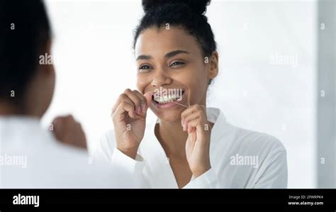 Happy Black Girl In Bathrobe Cleaning White Teeth With Floss Stock