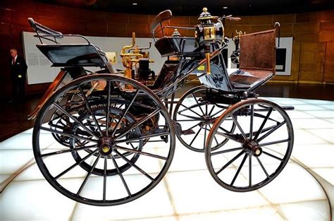 An Old Fashioned Carriage On Display In A Museum