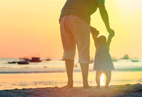 Father And Little Daughter Walking On Sunset Beach Fundación Isabel Gemio