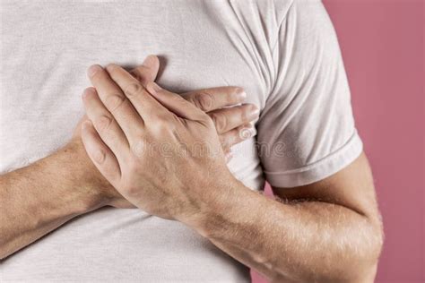 Man Holding His Chest With Both Hands Having Heart Attack Or Painful