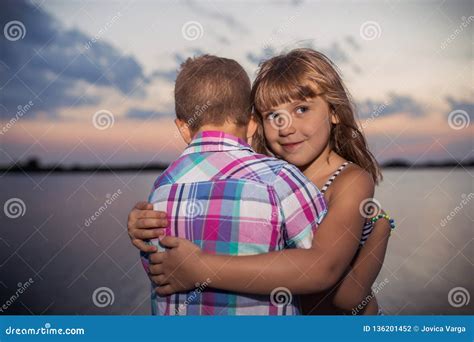 Little Boy And Girl Hugging By The River Stock Photo Image Of Nature