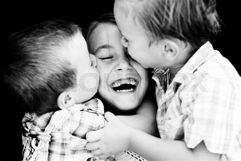 Two Little Boy Kissing A Girl Stock Image Colourbox