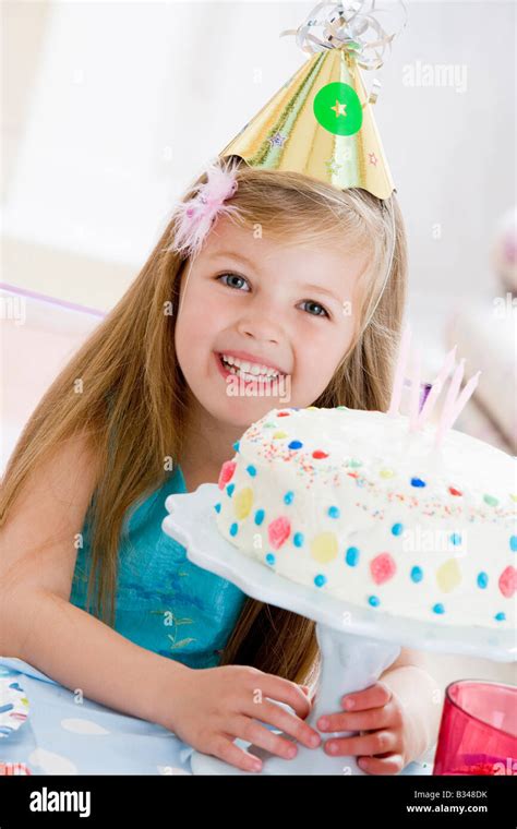 Young Girl Wearing Party Hat With Birthday Cake Smiling Stock Photo Alamy