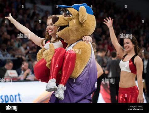 A mascot carries a member of the Brose Baskets Dance Team across the Stock Photo: 92933536 - Alamy