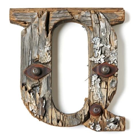 Premium Photo A Wooden Letter With Rusted Metal Rivets