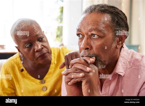 Senior Woman Comforting Man With Depression At Home Stock Photo Alamy