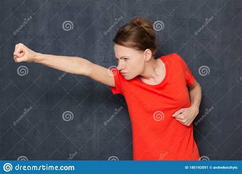 Portrait Of Angry Furious Young Woman Holding Fists Clenched Stock