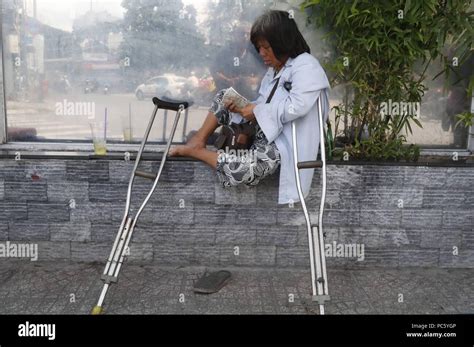 A Handicapped Woman With Crutches In The Street Ho Chi Minh City
