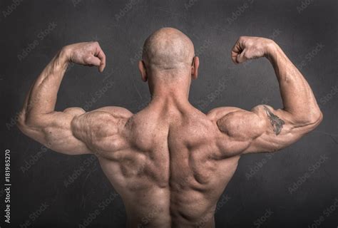 Back Double Biceps Pose By Brutal Caucasian Bodybuilder On Grunge