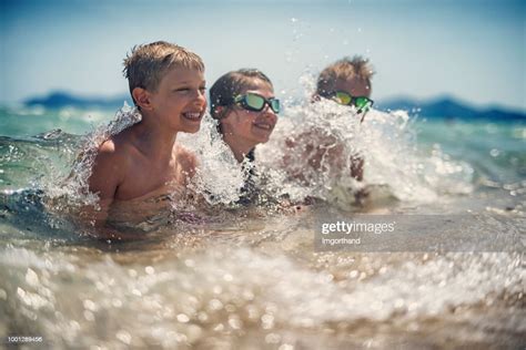 Kids Playing In Sea Waves High Res Stock Photo Getty Images