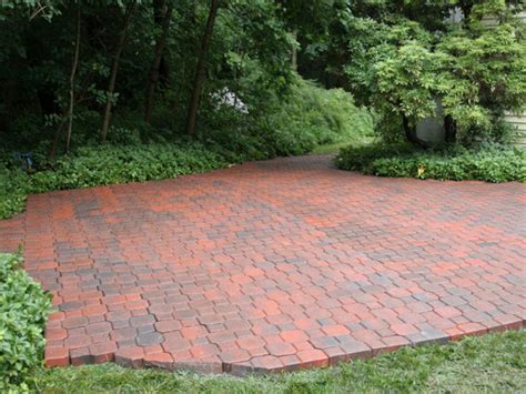 The crystal blue pool and slate paving stones make this patio an outdoor oasis. How to Build a Brick Patio | HGTV