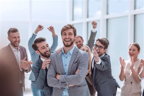 Close Up Cheerful Company Employees Applauding Their Colleague Stock
