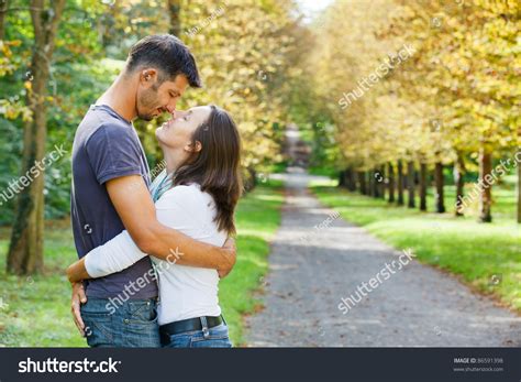 Romantic Beautiful Young Couple Walking In Autumn Park Stock Photo