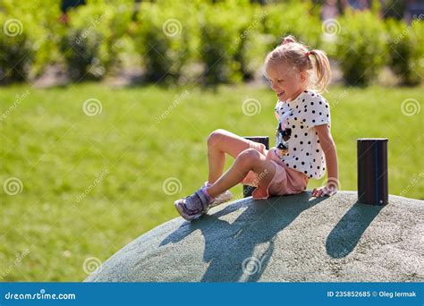 Active Blonde Girl Play On Obstacle Course In Playground In Summer Time