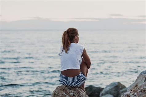 Woman Sitting On The Rock Looking To The Sea Stock Image Image Of