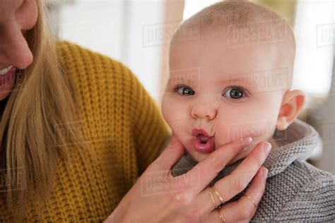 Mother Squeezing Babys Face Stock Photo Dissolve