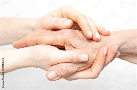 Helping Hand For The Elderly Concept With Young Hands Holding Old Hand