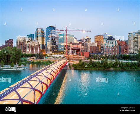 Calgary Downtown With Iluminated Peace Bridge And Full Moon Alberta