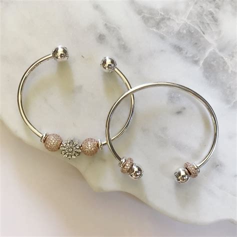 A sleek addition to your jewelry box, our pandora rose™ open bangle is minimally detailed with silicone stoppers that double as adornments. Open Bangle by Pandora- New Arrival at Versant in Bethlehem