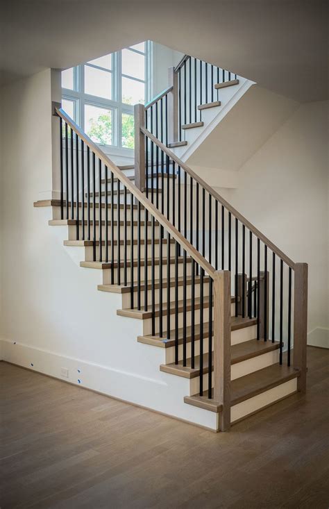 Wrought iron stair spindles provide a classic, sleek look. Metal Baluster System | Stair railing design, Modern stair railing, Modern stairs