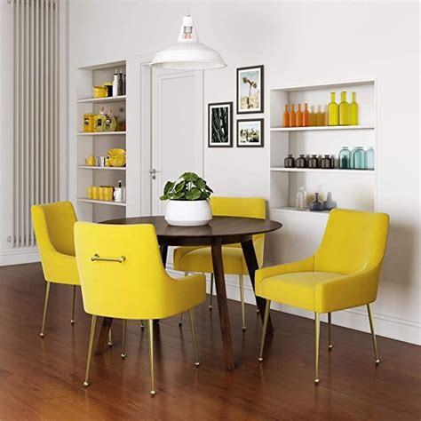 A Dining Room Table With Yellow Chairs Around It And Shelves On The