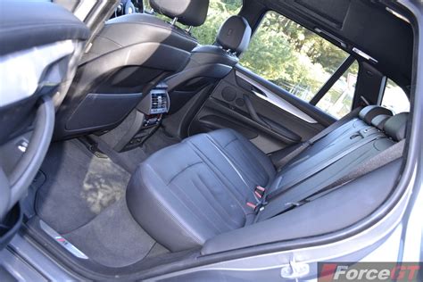 Compared to the front chairs, the rear seat cushion is mounted unexpectedly low in the cabin. 2014 BMW X5 M50d interior rear seats - ForceGT.com