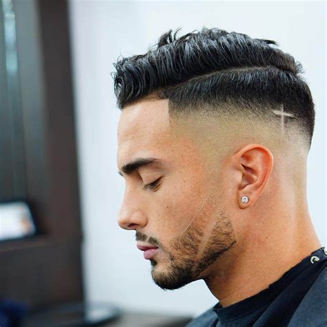 criztofferson high skin mid fade bald side part haircut god tattoo on