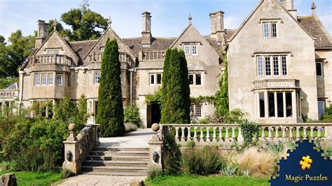 An Old Stone House With Ivy Growing On The Front And Stairs Leading Up