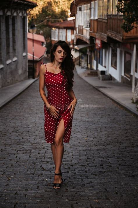 Young Caucasian Girl In Red Dress Posing On Beautiful Historical Street
