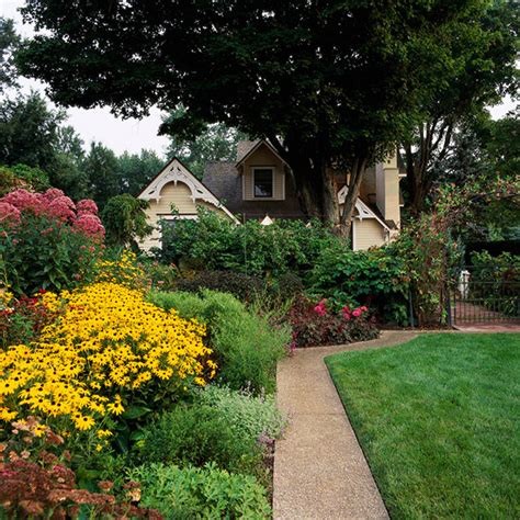 The clean symmetry of the poured concrete path is offset by the wild display of flowering plants. Big Ideas for Small Space Landscapes - Lifescape Colorado