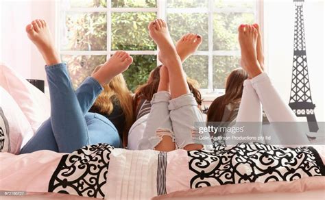Rear View Of Barefoot Caucasian Girls Laying On Bed Photo Getty Images