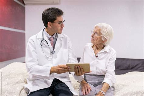 Doctor And Patient Discussing Treatment By Stocksy Contributor Per