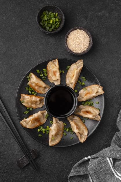 Cover and steam the usual way. Free Photo | Flat lay of traditional asian dumplings with herbs and chopsticks