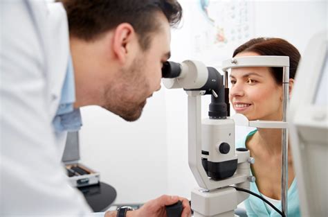 Optician With Tonometer And Patient At Eye Clinic Eye Clinic Of Livonia