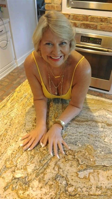 A Woman Laying On Top Of A Rug In A Kitchen